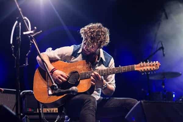 man using a capo in a concert