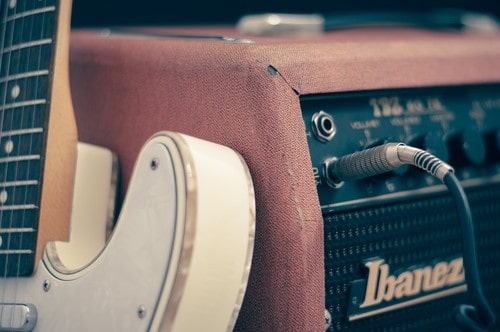 guitar pedal plugged into amp with lead