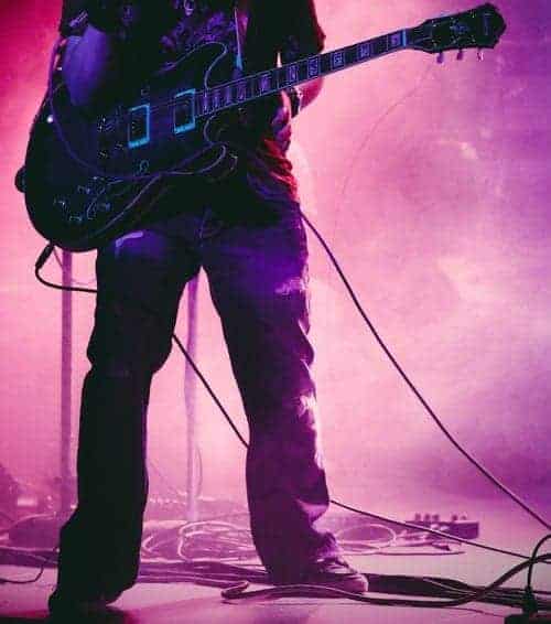 guitarist on stage with guitar leads