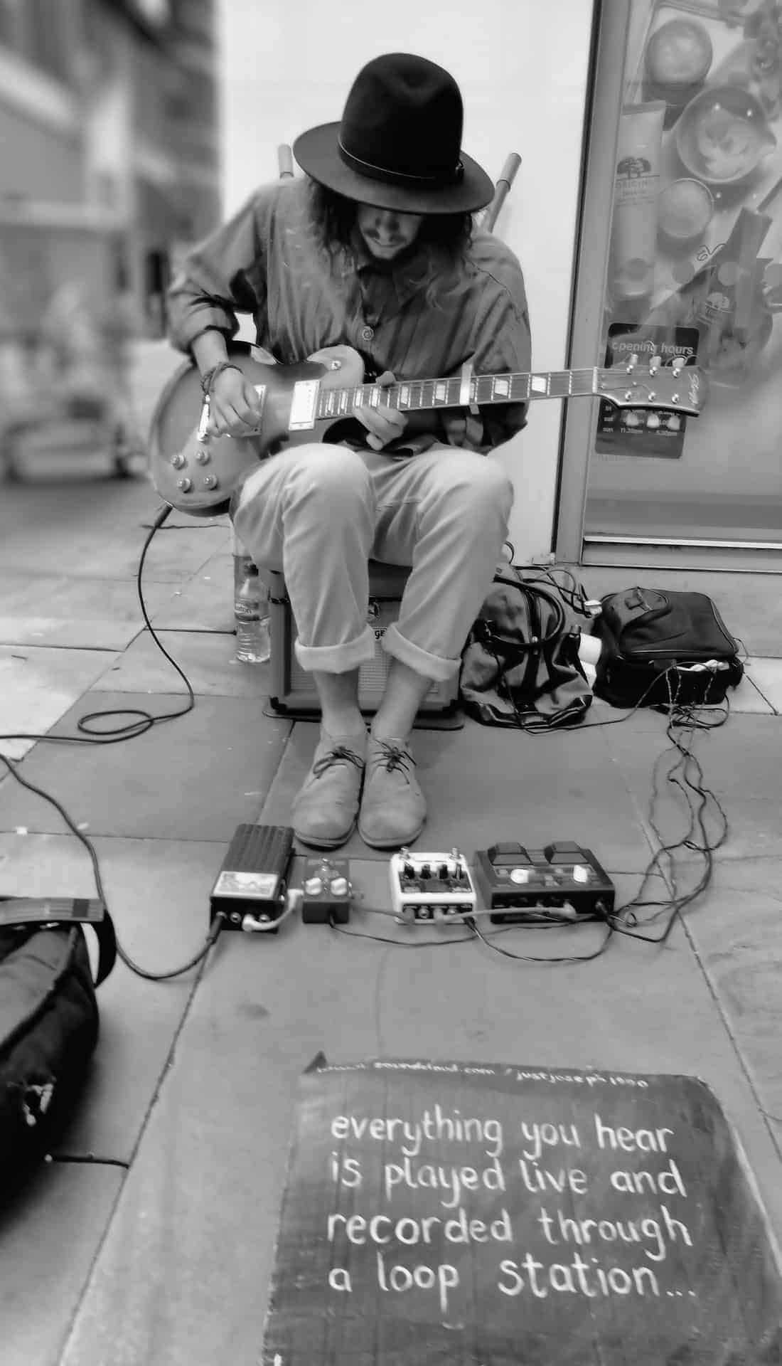 busker using a capo as part of his setup